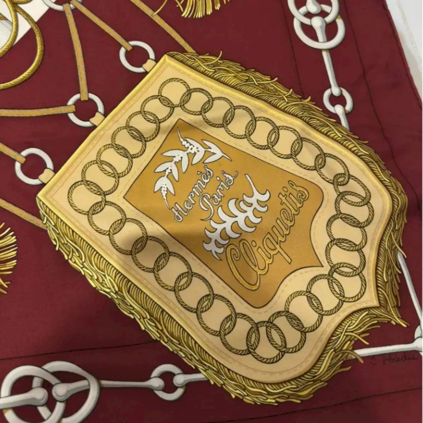 HERMÈS CLIQUETIS BURGUNDY AND GOLD SILK SCARF