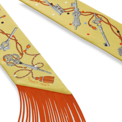 HERMÈS YELLOW SILK TWILLY WITH LEATHER FRINGES