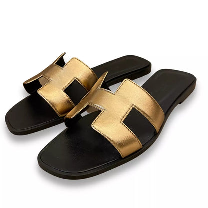 Sandalias Hermes en color naranja, negro y dorado 